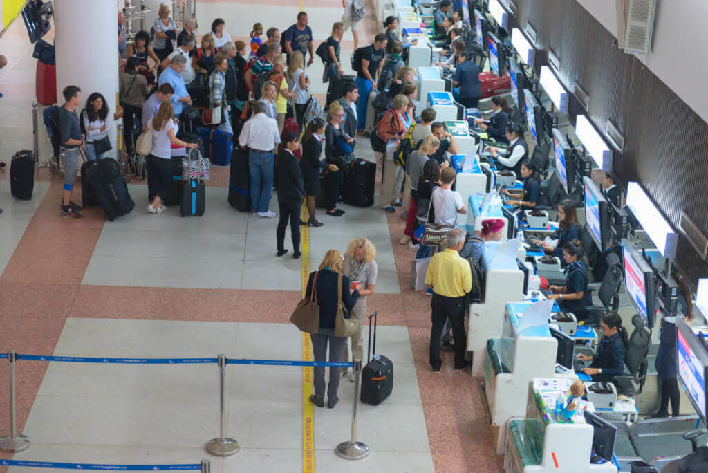 passenger queue near check in desks in airport passenger queue near check in desks in airport